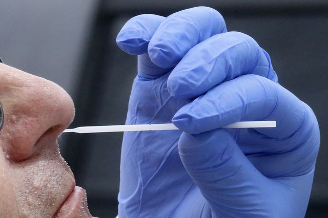 A nurse uses a swab to perform a coronavirus test in Salt Lake City on June 12th, 2020.